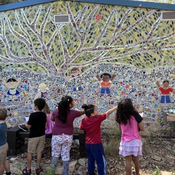 Students gathered around an artwork