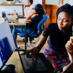 Student and teacher reviewing project on computer