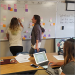 teachers at a whiteboard brainstorming